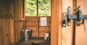 The wood-crafted communal toilet at The Farm Camp in Wiltshire