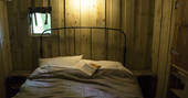 Relax in the comfortable and cosy double bed in Hartland safari tent, Berridon Farm, Devon