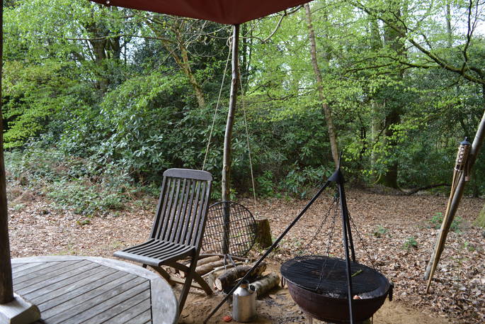 Table and chairs by the fire-pit at Chestnut yurt, Adhurst