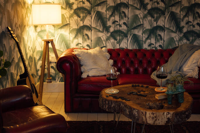 Lounge area at the nook with sofas and a guitar to use