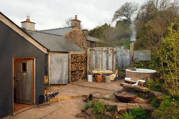 The Nook has a wood burning hot tub, firepit and a bench