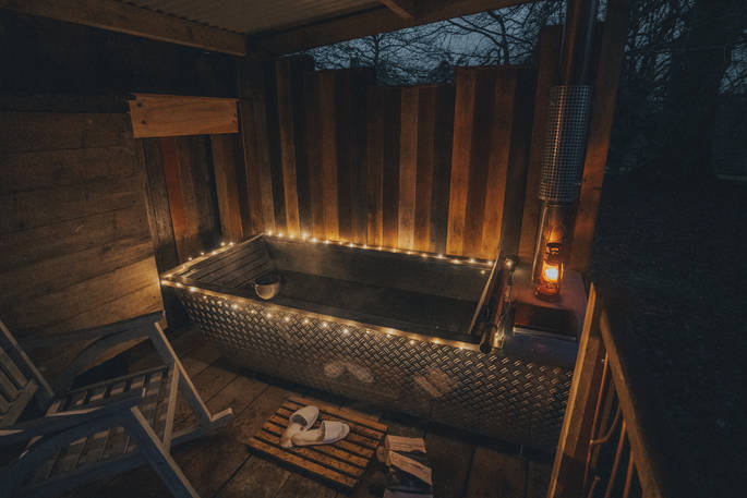Wood burning hot tub in the evening