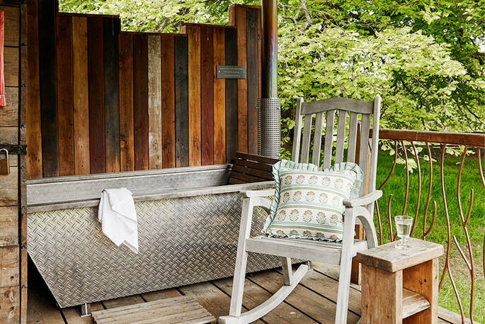 Wood-fired bath tub in the covered deck area