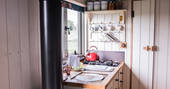 Kitchen and utensils inside Dimpsey shepherd's hut in Somerset 