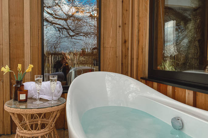Meadow Cabin at Beneath The Branches outdoor bath tub, Ashurst, Sussex, England