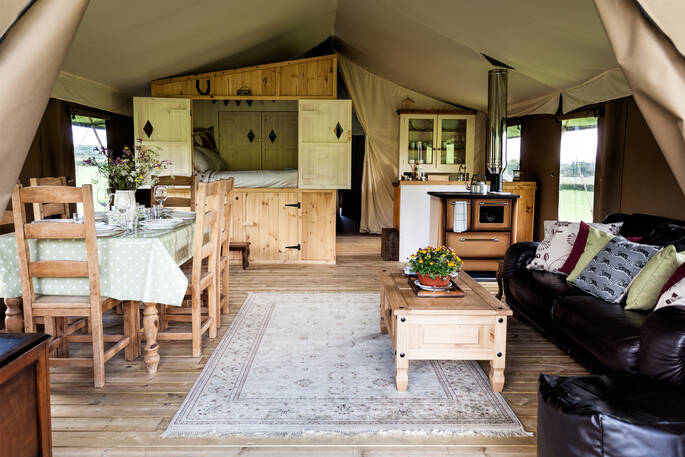 Interior of the Onnen Lodge with cabin bed and dining table in Angelsey, Wales