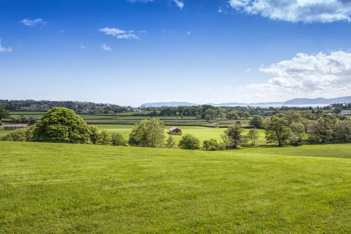 A view across the rolling green fields at Wonderfully Wild in Anglesey, Wales