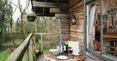 Enjoy a glass of wine on the verandah of Log House Studio, Carmarthenshire