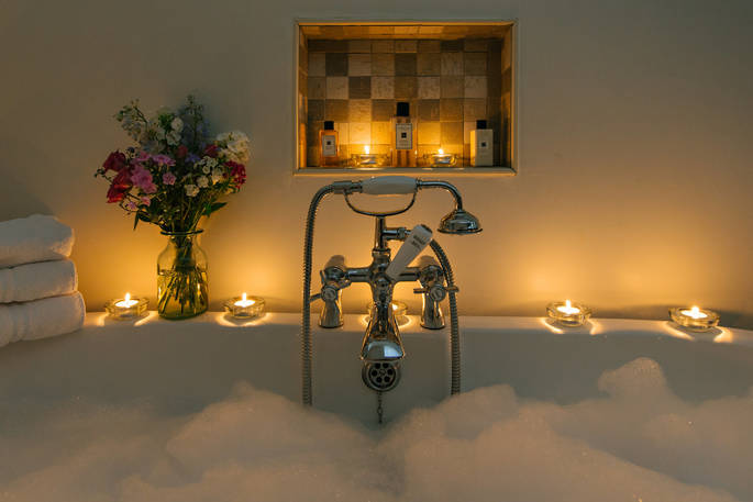 Relax and unwind in a candelit bubble bath at Penhein Glamping in Monmouthshire
