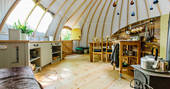 The kitchen and dining area inside The Cribbau tent at Penhein Glamping in Monmouthshire