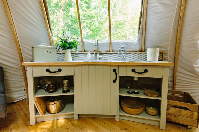 Fully-equipped kitchen area inside The Cribbau tent at Penhein Glamping in Monmouthshire