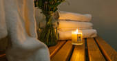 Candle and fluffy towels at Penhein Glamping in Monmouthshire