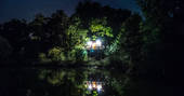 Gauthie Lakeside Treehouse lit up at night, Dordogne, France