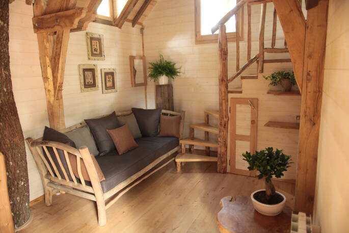 milandes dordogne france europe european glamping sunshine holidays cabin interior treehouse rustic wooden staircase beside living area
