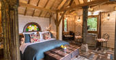 Inside Monbazillac Treehouse, double bed and seating area, Châteaux dans les Arbres, Dordogne, France