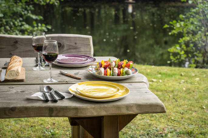 Alfresco dining with red wine at the Poacher's Cabin in Dordogne, France