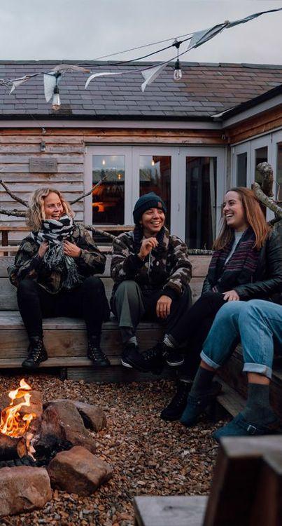 Canopy and Stars team sat around a campfire