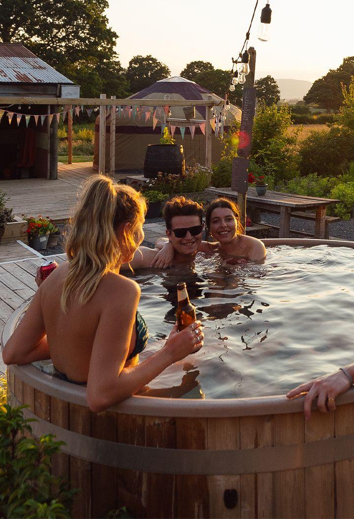 Box Barn garden with people in hot tub 