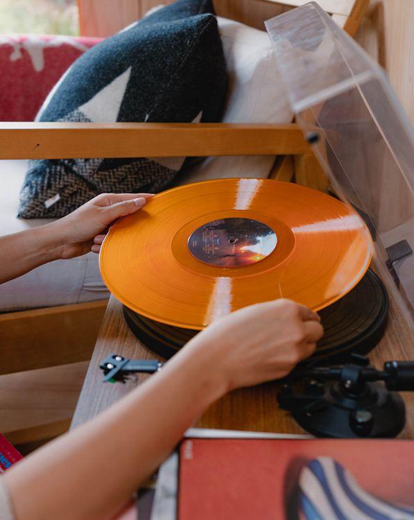 Person putting a record onto a record player