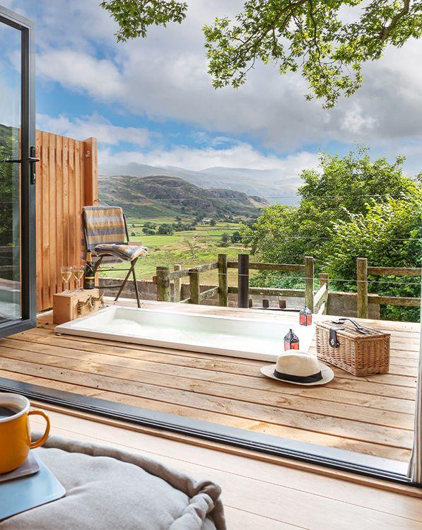 Bath in decking with lamps and view 