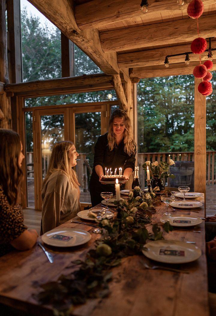 Journeyman Treehouse interior with people celebrating birthday 