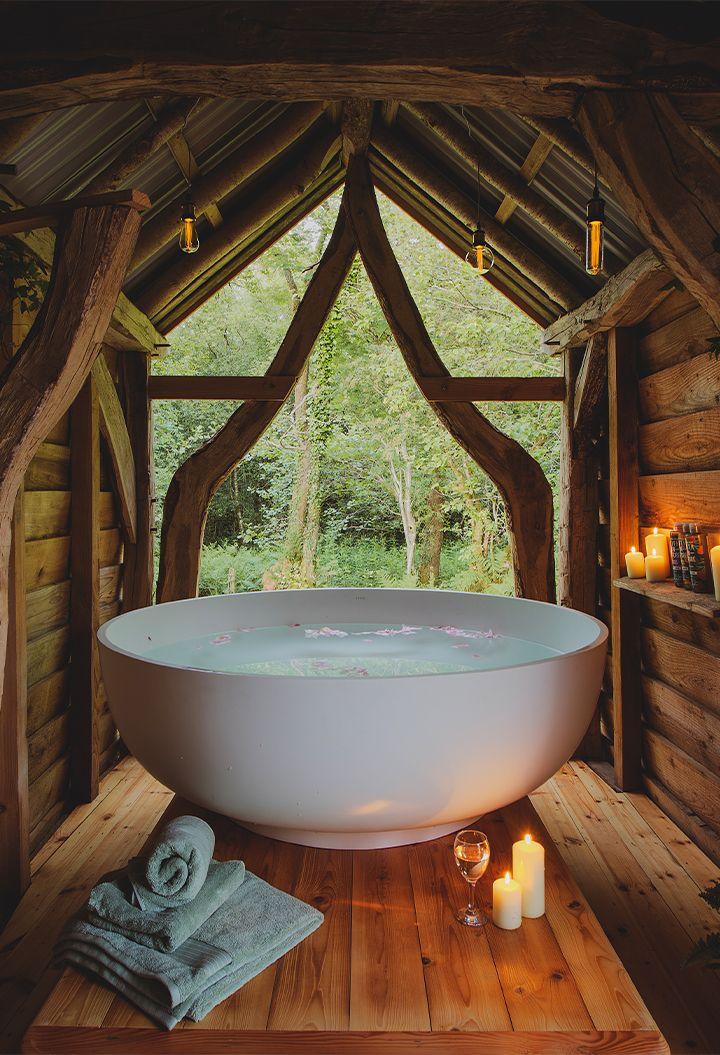 Large bowl bath in wooden cabin 