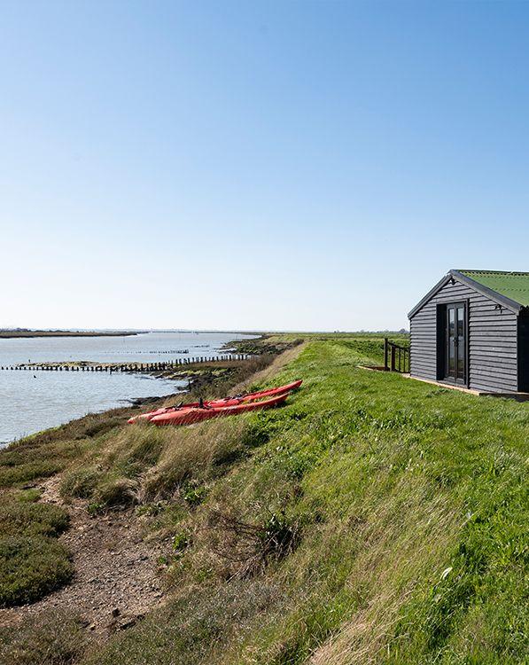Samphire exterior with kayaks and estuary