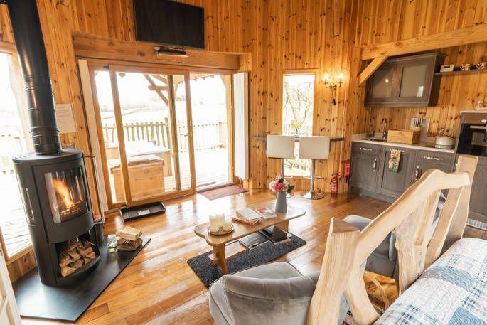The Lodge Treehouse interior with wood burner and view 