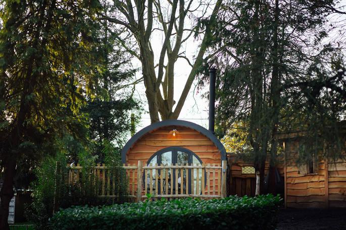 Vilberie cabin exterior with large circle window and woodland 