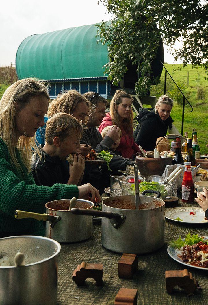 Vintage Vardos exterior with group of people eating 