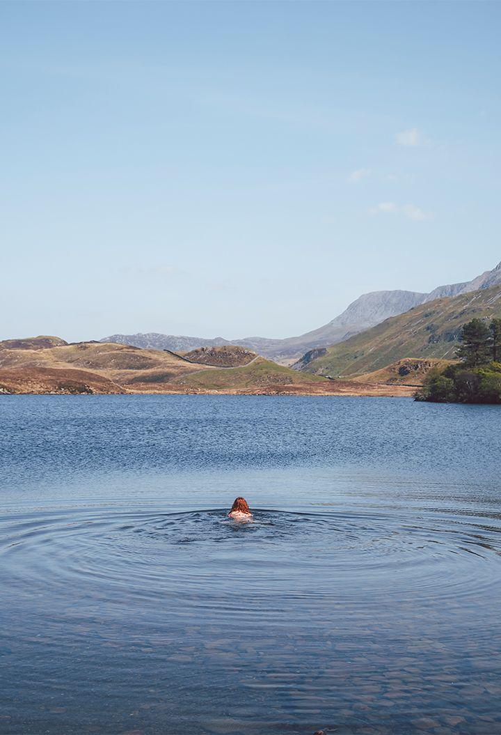 Person wild swimming in a rural area 