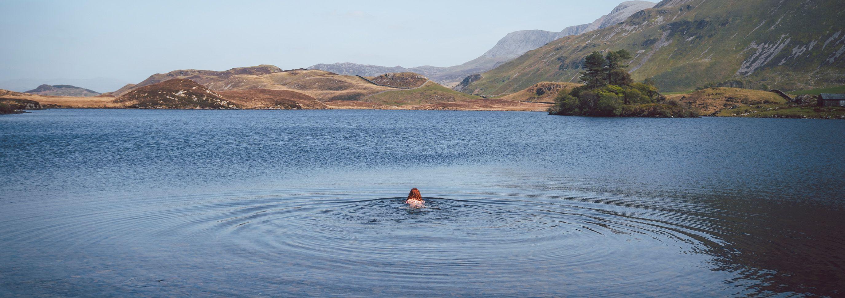 Person wild swimming in a rural area 