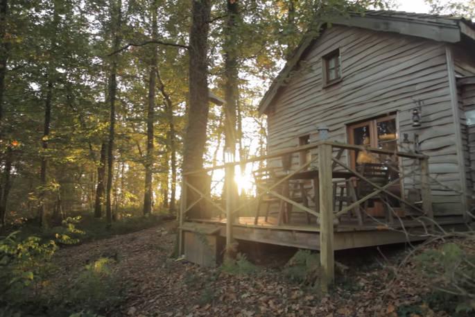 Woodsman's Cabin at sunset with decking and outdoor seating