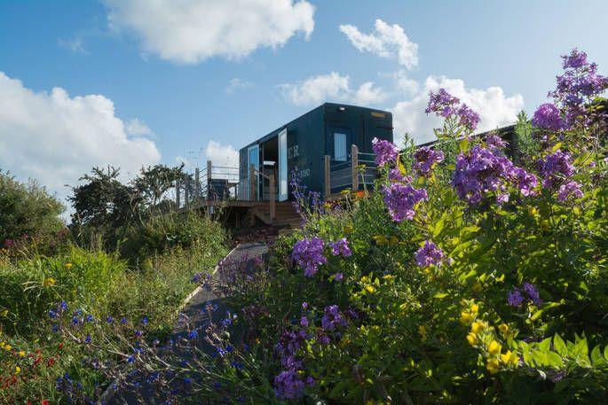 Pantechnicon Powys exterior with hill and flowers 