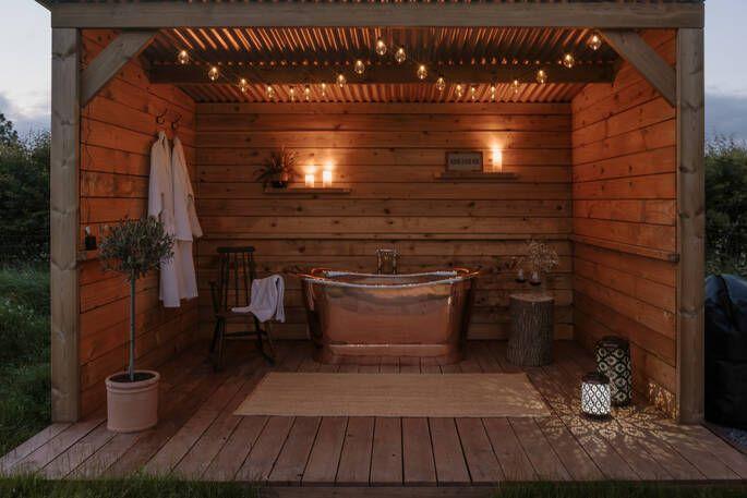 The Snug outdoor bath area, with fair lights, robes and shelter