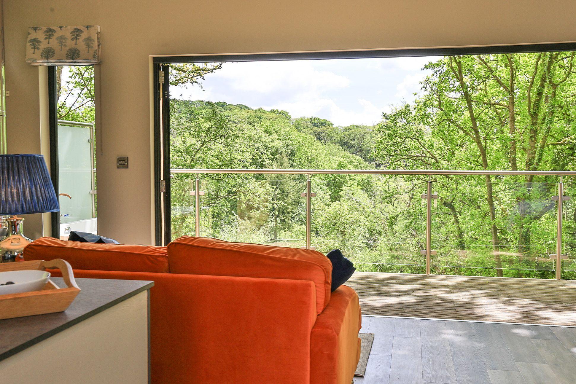 The Wonham Oak living room with large window and view of the woodland