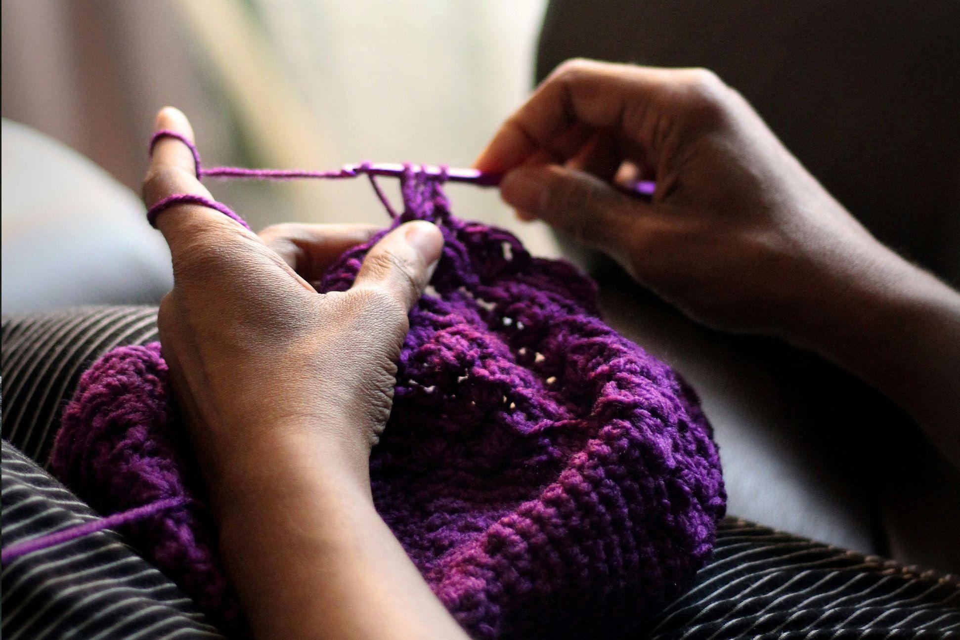 A person crocheting 