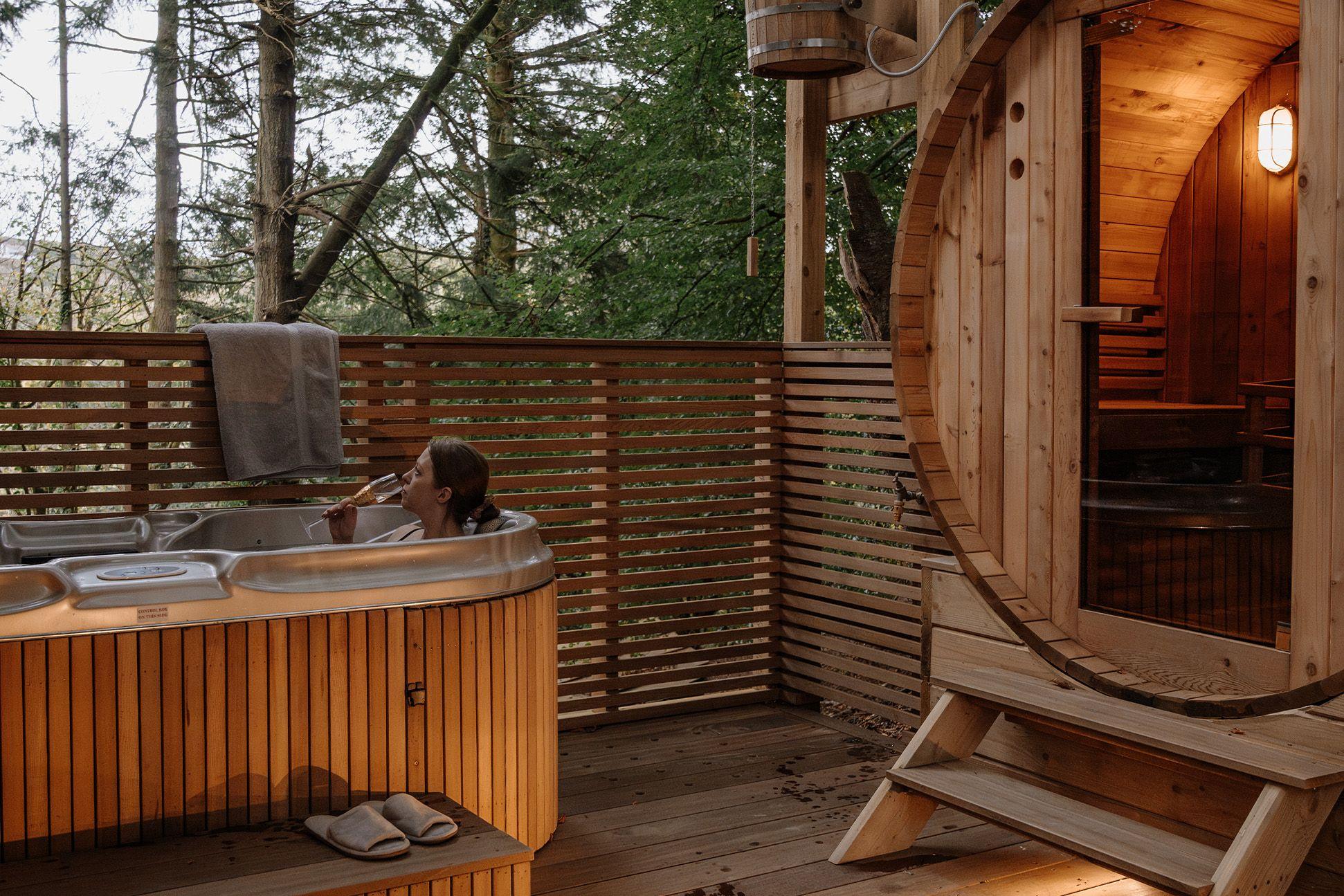A person in a hot tub with a sauna 