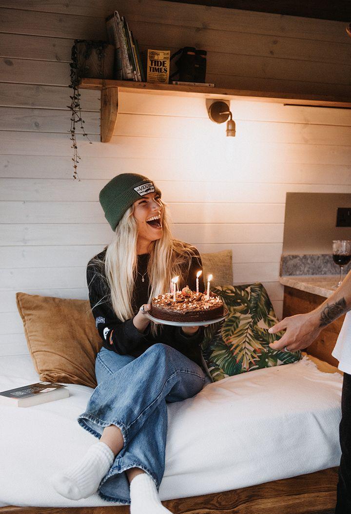 Person holding birthday cake with candles 