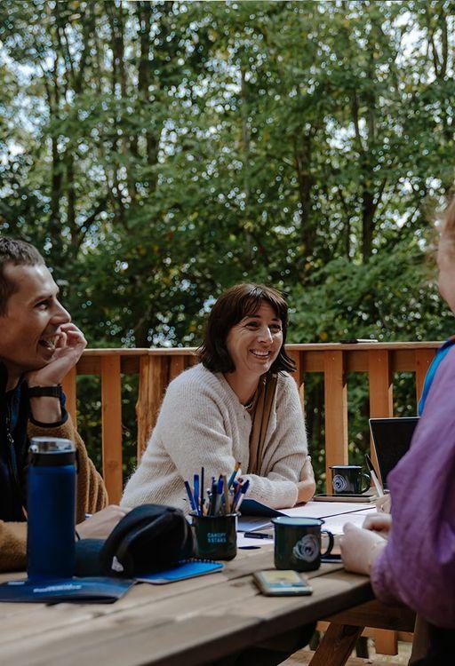 People sitting at an outdoor table laughing