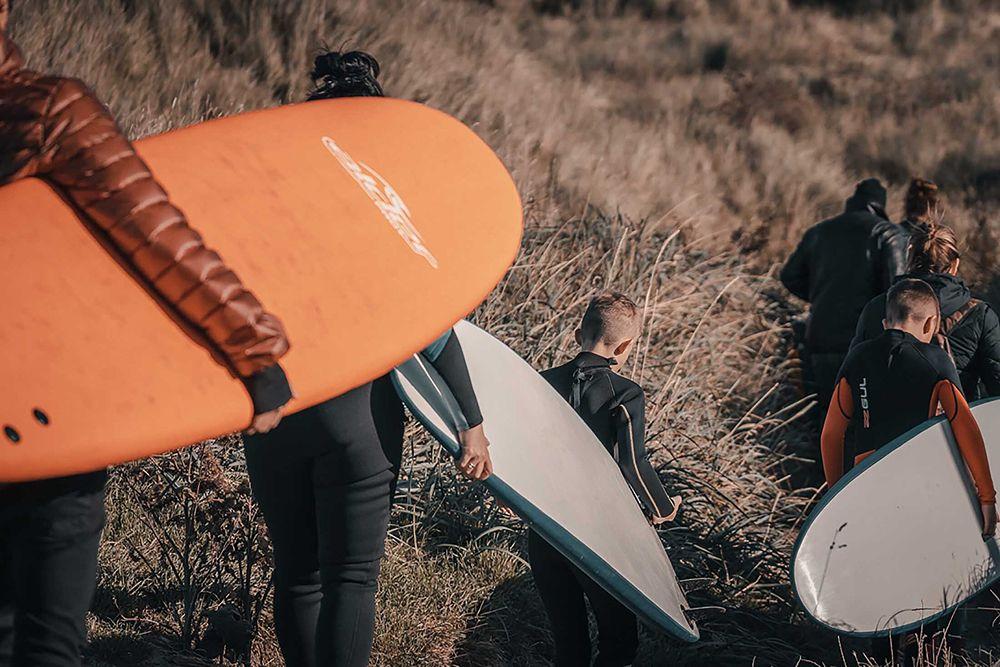 A family heads down the dunes to the water