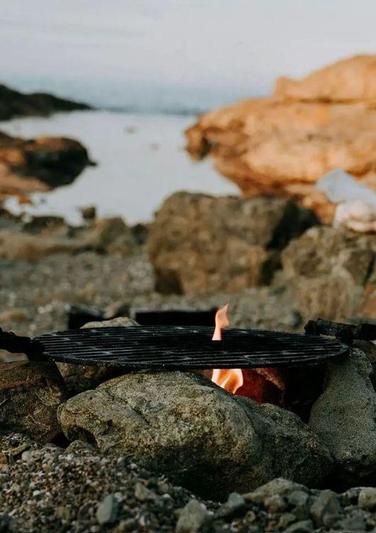 Stack of stones over a fire to cook on the beach