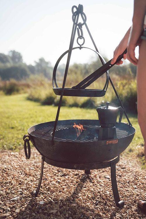 Iron skillet cooks above firebowl