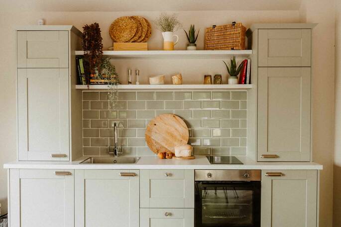 Kitchen equipped with an electric hob, oven, kettle and all cooking utensils