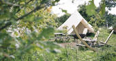 Cotton Breeches bell tent camp with communal campfire and outside dining space