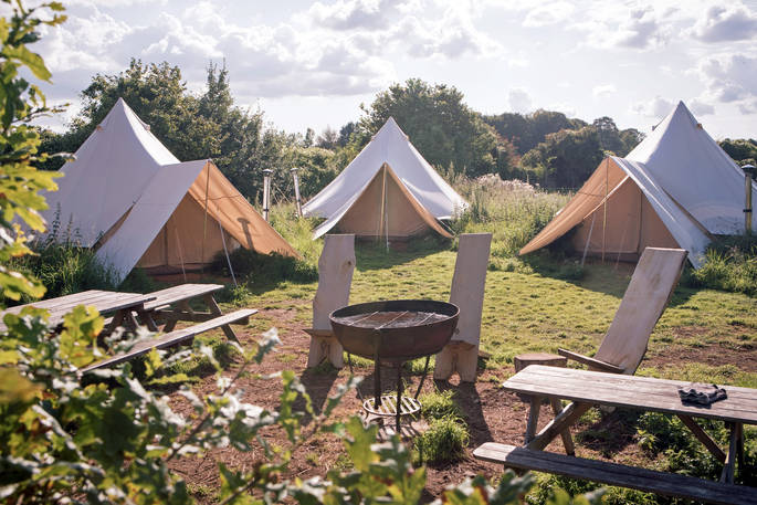 Cotton Breeches bell tent camp near Bath with outside seating and communal camp fire to gather together