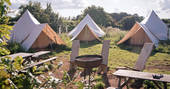 Cotton Breeches bell tent camp near Bath with outside seating and communal camp fire to gather together