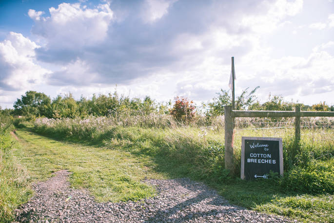 Sign and path leading to Cotton Breeches camp at The Farm Camp