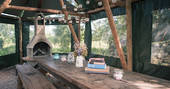 Covered outside dining area at Cotton Breeches with large barbecue for group meals