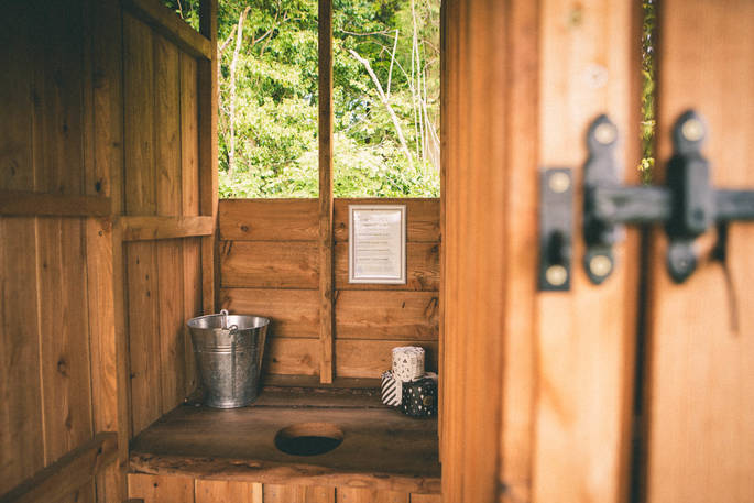 The wood-crafted communal toilet at The Farm Camp in Wiltshire